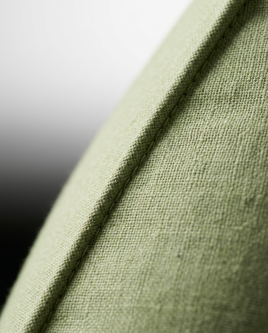 Close-up of the piped edge seam on the green reading backrest cushion
