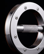 Polished steel ring with hex bolts and a knurled handle bar across the center