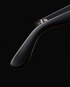 Close-up of the glossy black tapered temple arm of the blue light glasses