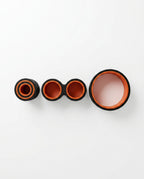 Three back rollers in small, medium and large sizes lined up on white