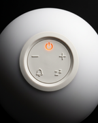 Macro of the top control buttons with orange power icon on the wake-up light