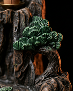 Macro of the hand-painted green pine tree detail on the incense holder