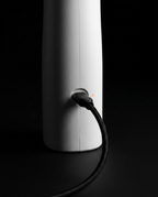 Macro of the USB-C charging cable plugged into the base of the water flosser
