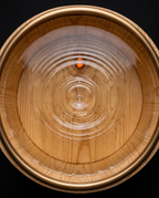 Top-down view into the sauna bucket showing the liner and rippling water