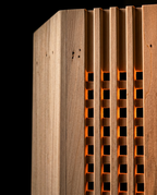 Detail of pine wood grain and lattice openings glowing on the light cover