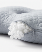 Open zipper revealing white pearl-cotton filling inside the grey sleep pillow