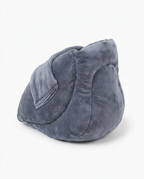 Three-quarter back view of the grey velvet heel cushion pillow on white