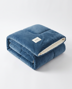Blue color variant of the plush winter comforter, folded studio shot