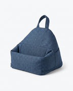 Denim blue tablet stand pillow shown at an angle with handle and pocket