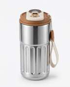Silver temperature display mug with brown lid and strap, side view on white