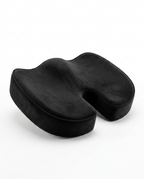 Black velvet-cover memory foam seat cushion with coccyx cutout, angled view
