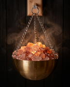 Brass sauna bowl filled with pink Himalayan salt crystals and steam
