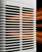 Macro of the white air vent louvers with amber light behind