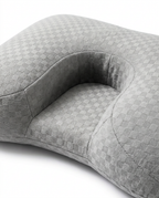 Close-up of the sleep pillow's sculpted arm-cradle and neck-support contour zones
