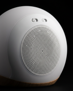 Macro of the rear speaker grille and ports on the white wake-up light