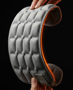 Hands flexing the grey gel pad into a curve to show its flexibility