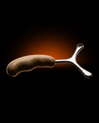 Side silhouette of the full fascia massage tool against a warm glow