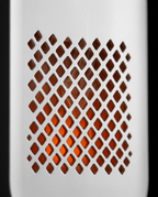 Macro of the diffuser's diamond-pattern grille glowing warm orange