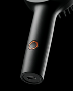 Macro of the illuminated power button and USB-C port on the brush handle