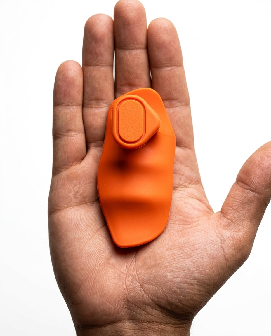 Open palm holding single orange silicone grip pad showing compact size
