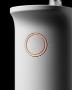 Close-up of the circular mode-control button on the water flosser handle