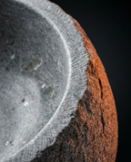 Macro detail of the rounded rim and grain of the natural stone bowl