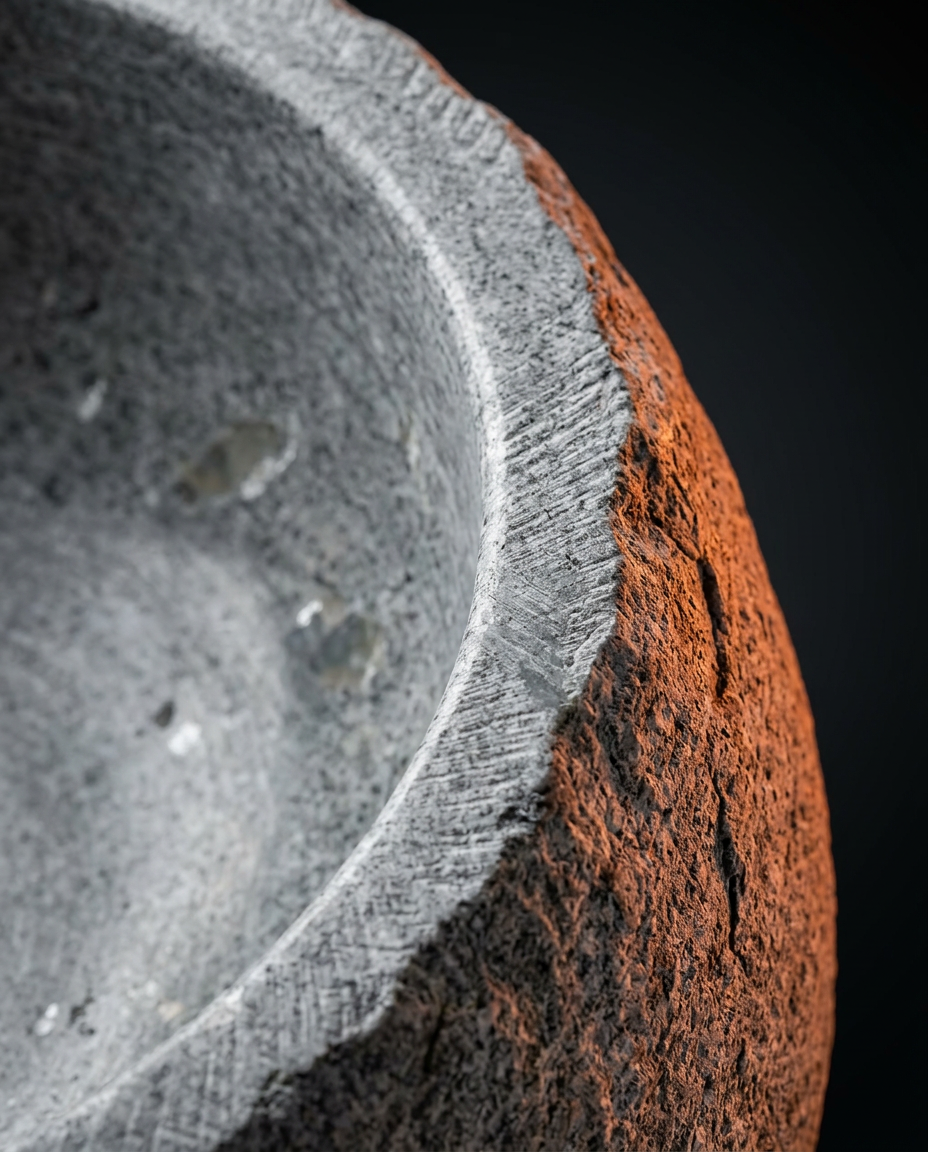 Macro detail of the rounded rim and grain of the natural stone bowl