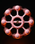 Front view of the spinning pink rotation trainer with glowing motion halo
