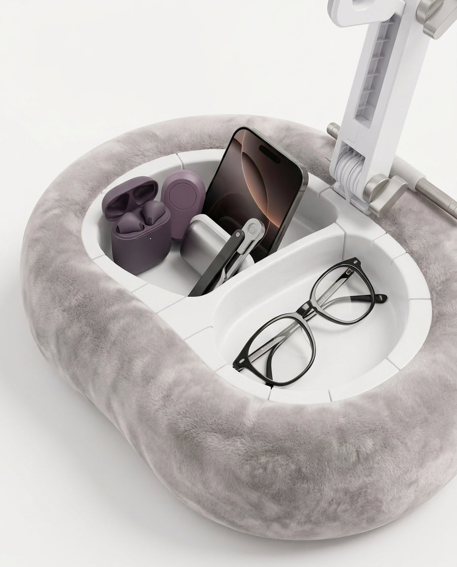 Built-in storage compartments of the pillow stand holding earbuds, phone and glasses