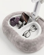 Built-in storage compartments of the pillow stand holding earbuds, phone and glasses