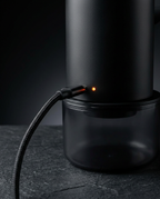Soap dispenser charging via magnetic USB-C cable with orange charge light