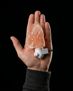 Compact Himalayan salt lamp resting in an open palm to show its small size