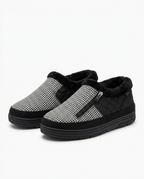 Black-and-white houndstooth heated slippers with side zip, studio packshot