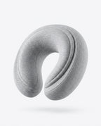 Light grey U-shaped memory foam travel neck pillow, studio shot on white