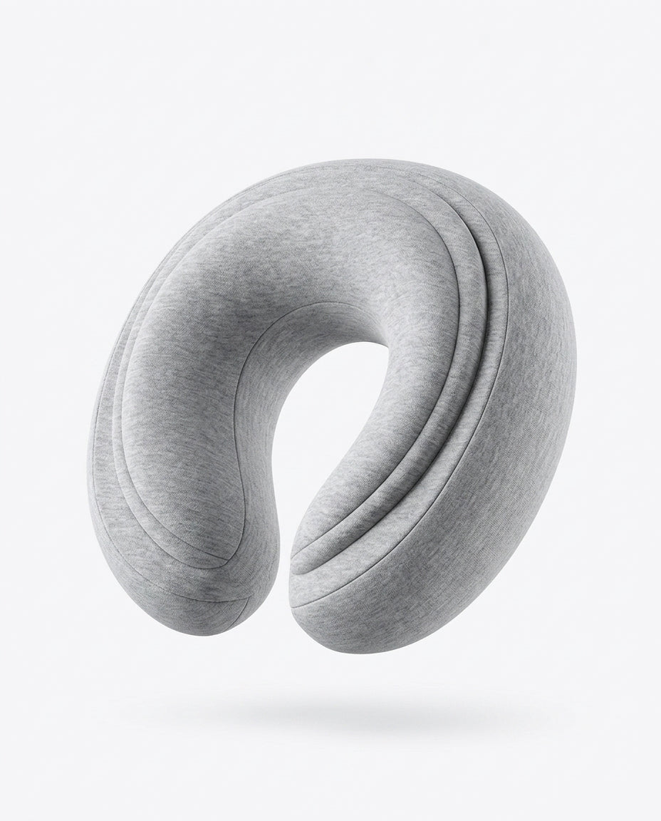 Light grey U-shaped memory foam travel neck pillow, studio shot on white
