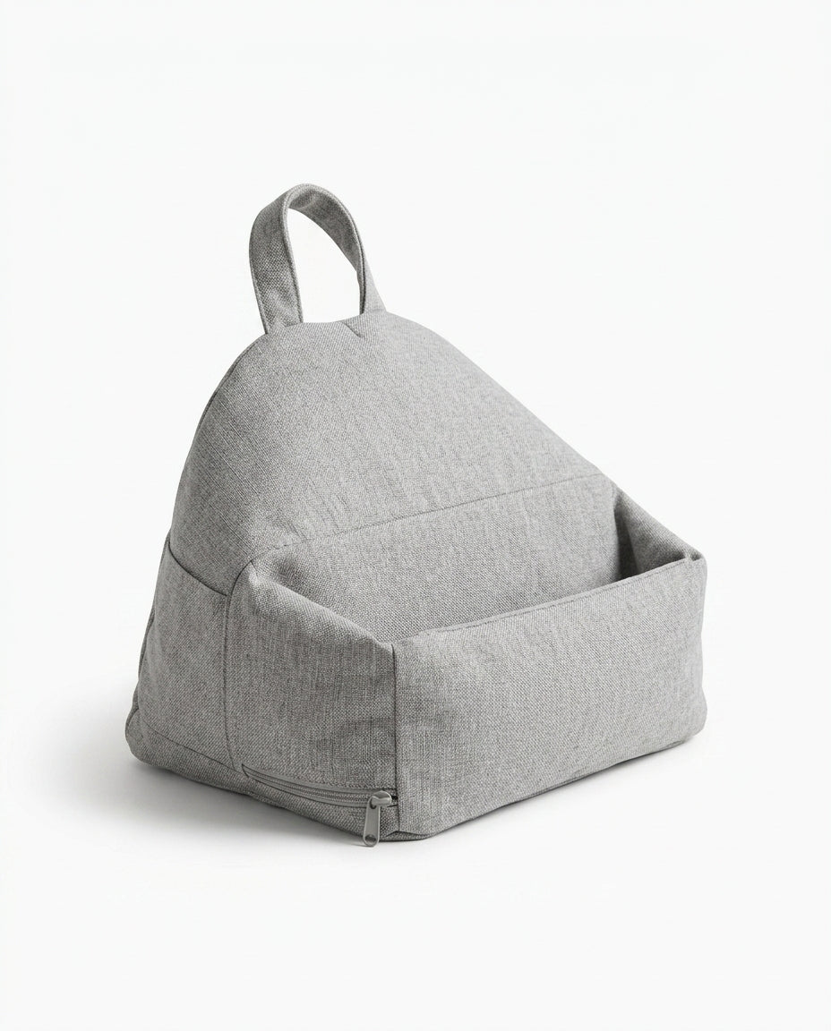 Light grey tablet stand pillow shown at an angle with handle and pocket