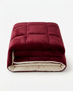 Burgundy red color variant of the plush winter comforter, folded studio shot