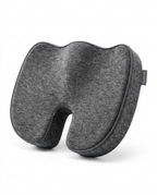 Heathered grey memory foam seat cushion with coccyx cutout on white