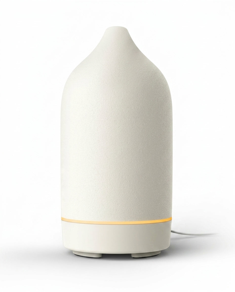 White ceramic essential oil diffuser with glowing base ring, on white