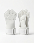 Pair of white paw-shaped lifting grips with wrist straps on white