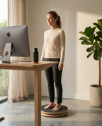 Woman balancing on the board at a standing desk during a work microbreak