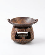 Bronze ceramic burner with a round handled bowl dish, front view on white