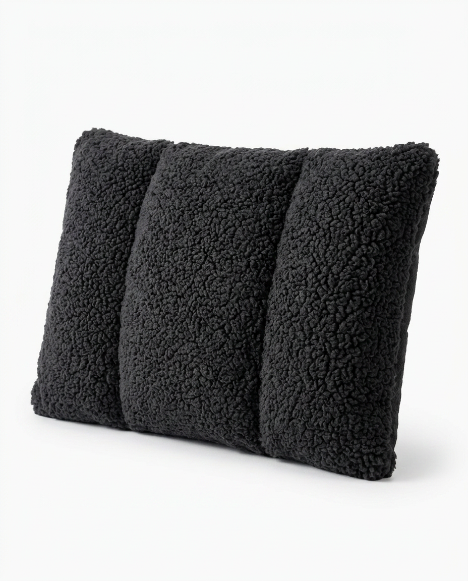 Black sherpa lumbar support pillow with quilted channels on white