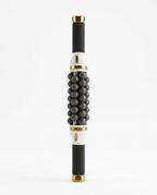 Gold-accent variant of the rolling massage stick, studio on white