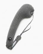 Grey variant of the inflatable travel neck pillow with strap on white