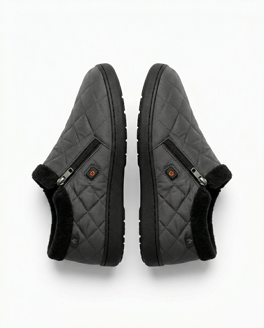 Grey quilted nylon heated slippers shown as a pair from above