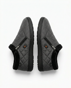 Grey quilted nylon heated slippers shown as a pair from above