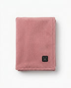 Folded dusty pink heated comfort scarf with flame logo tab on white