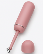 Dusty pink travel bidet bottle open with cap removed on white background