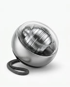 Platinum brushed-metal gyro ball trainer with clear dome and grey strap on white